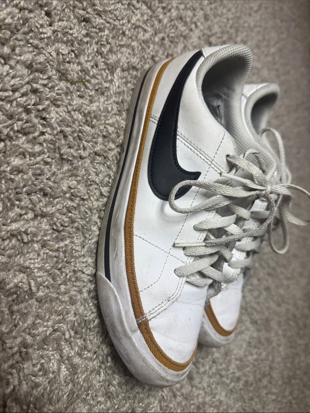 Nike Men’s White Sneakers with Black Swoosh and Gold Accent